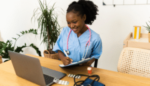 black doctor attending to patients through a computer